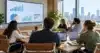 Team at a conference table reviewing charts on a wall display, illustrating responsible use of AI writing statistics